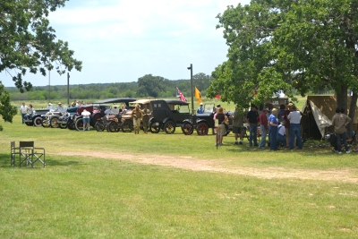 Re-enactor's camp and antique vehicle line