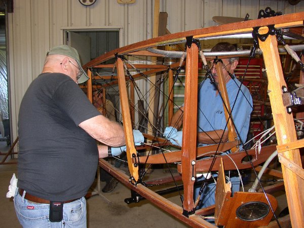 Safety-wiring turnbuckles on the Thomas-Morse fuselage