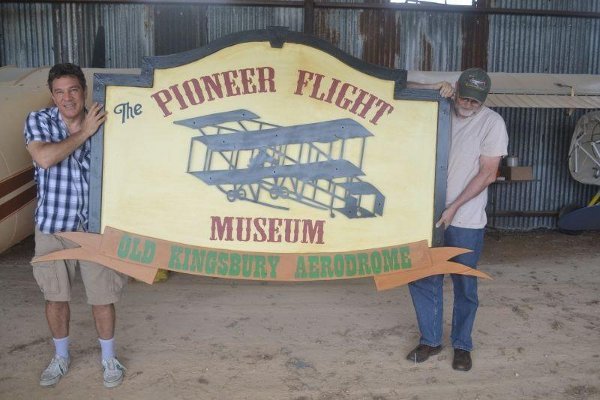 Carl Canga (left) and Dan Siegle holding the new sign